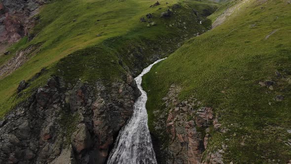 High Powerful Waterfall Streams Fall From Narrow Canyon