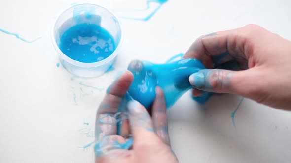 Girl Stretching Blue Slime to the Sides