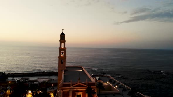 Drone shot flying forward the clock tower of Jaffo Tel Aviv 4K