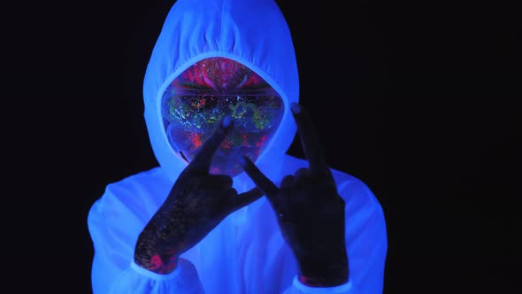 A Girl in a White Luminous Suit and a Mask Under the Light of Fluorescent Lamps