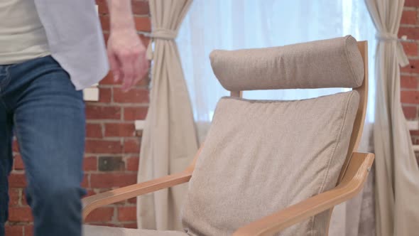 Casual Young Man Coming Back Sitting on Sofa