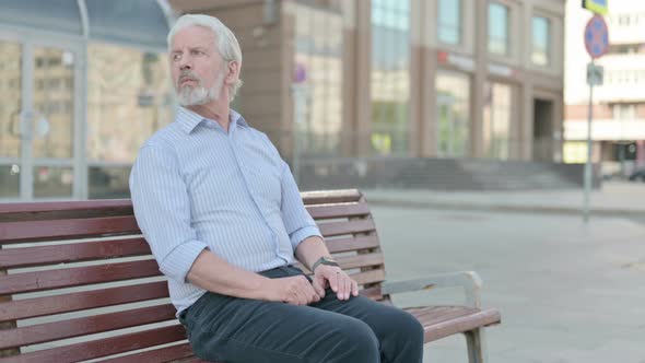 Old Man Standing and Leaving After Sitting on Bench Outdoor