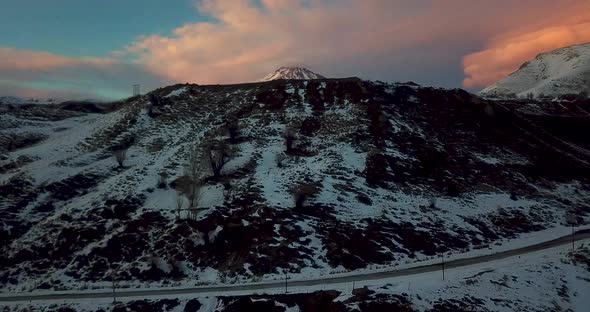 Rising Drone Shot In A Cold Sunset Golden time In Winter From A Village Road To Damavand Mountain Su