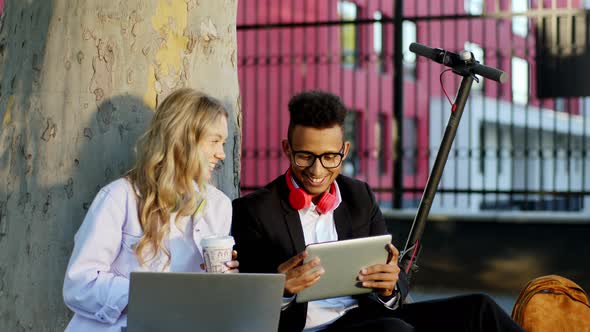 Multiracial Students Lady and Guy Sitting Down on