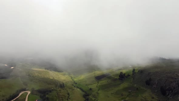 Thick Clouds Covering Green Andean Landscape In Cumbemayo, Cajamarca, Peru. Aerial Drone