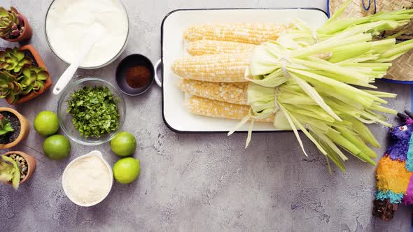 Step by step. Shucking organic corn to make Mexican corn on the cob Elote.