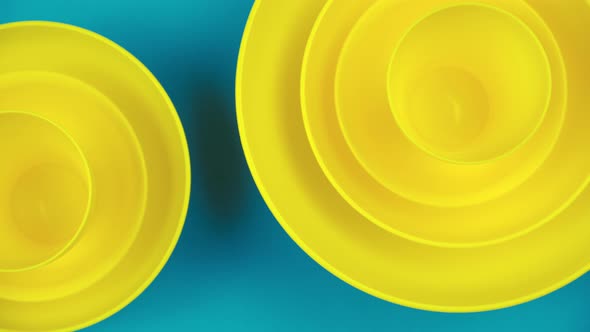 Flat Lay Yellow Cups on a Turquoise Background. Harsh Pastel Colors. Minimalistic Design Style.