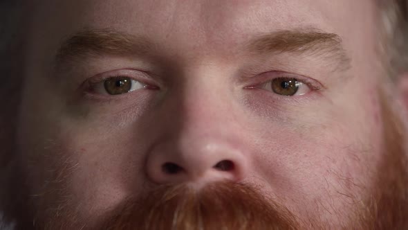 Tight shot of mans nose and eyes looking at camera