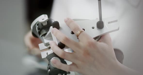 A female dentist technologist holds a mock-up of a jaw in her hands. Making dentures