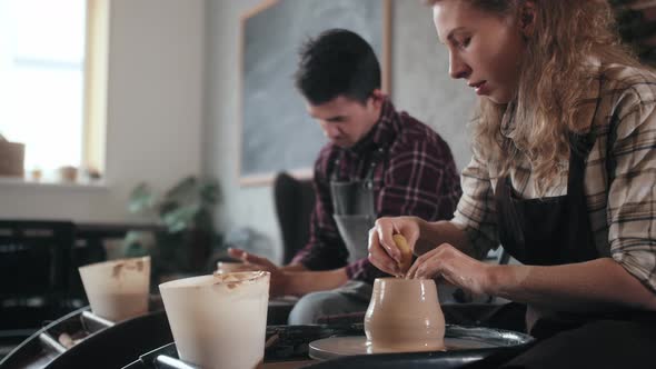 Potter Masterclass Man and Woman are Working with Pottery Wheel Making Pots During Master Class for