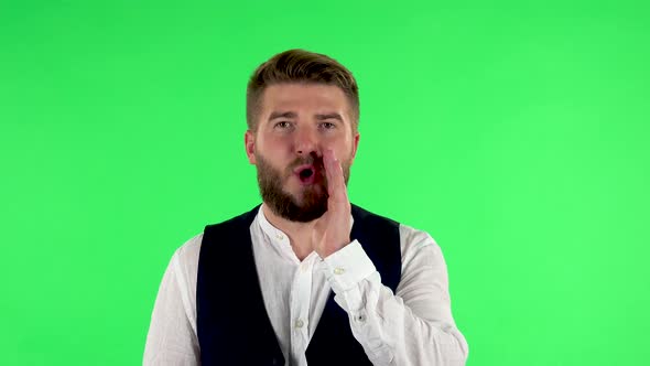 Man Screams Calling Someone on a Green Screen at Studio.