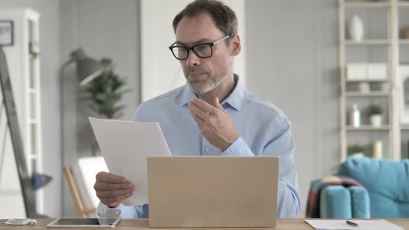 Old Businessman Reading Contract