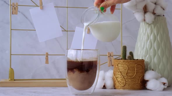 Woman Add Milk to Cup of Coffee