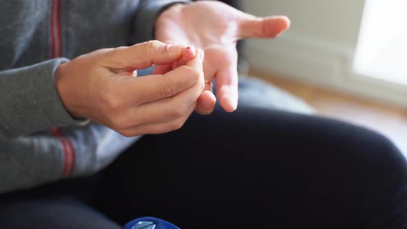 Close Up of Young Woman Hands with Glucose Meter. Blood Testing at Home. Metabolic Syndrome