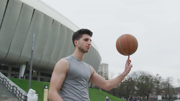 Basketball player spinning ball in the air