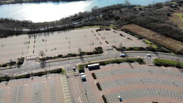 Aerial - A parking lot in a park nearby lakeside. Sunny day in Tower Square, Northampton, United kin