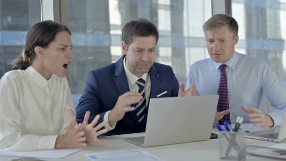 Executive Business People Get Shocked While Using Laptop on Office Table