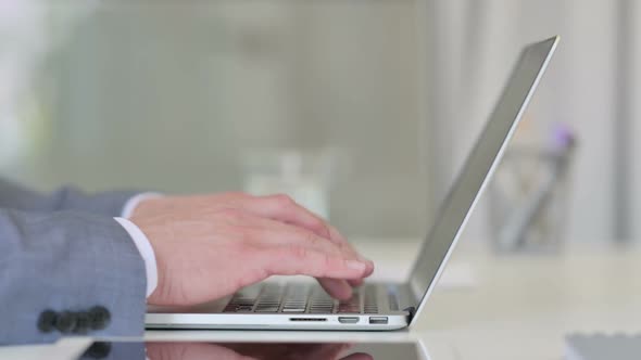 Close Up of Businessman Working on Laptop