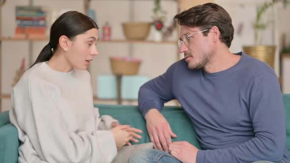 Hispanic Woman Fighting with Male Partner While Sitting