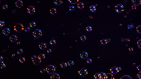 Blue and Orange Soap Bubbles on Black, Background, Close Up, Slow Motion