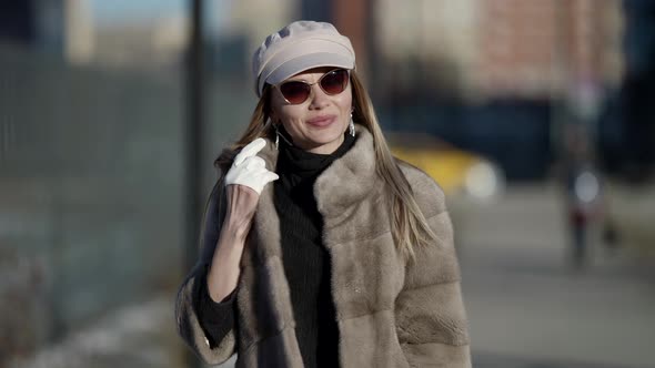 Sexy Blonde Woman in Fur Coat Is Walking Alone in City Closeup Portrait of Smiling Pretty Face