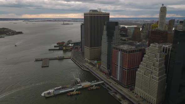 Aerial Footage of Tall Buildings and Busy Coastal Road at Twilight on Overcast Day