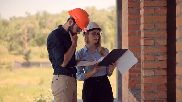 Two Engineer Builder In Hard Hat Inspecting Building.Real Estate Building Project Architect.