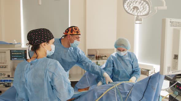 Surgeons Team Performing Operation in Hospital Operating Theater Male Surgeon