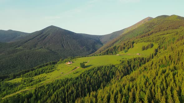 Aerial Flight Over the Fairytale in the Mountains with a Cheese Factory and Old Wooden Houses