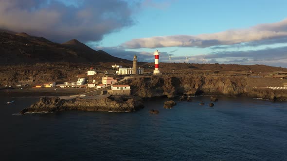 Majestic scenery of coast with beacon at sunset