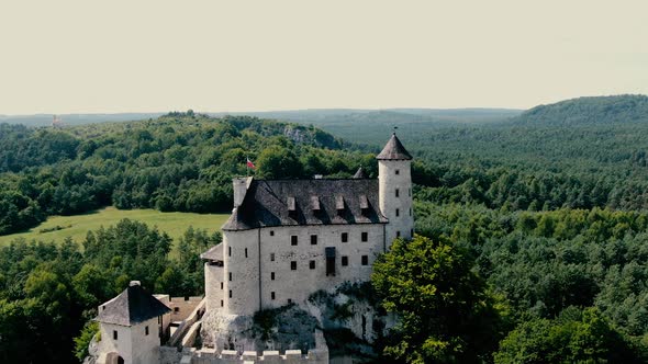 Bobolice medieval castle in a green land landscape aerial view. Poland. Dolly zoom