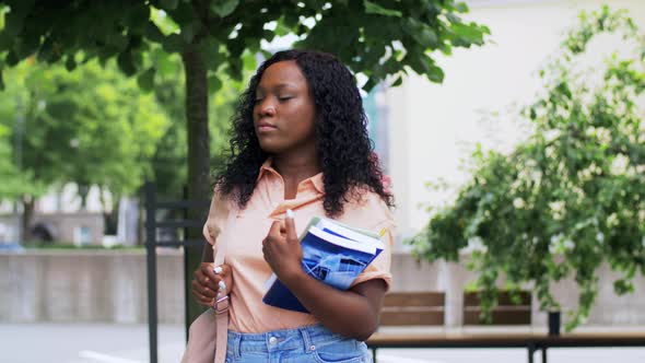 African Student Girl with Notebooks in City