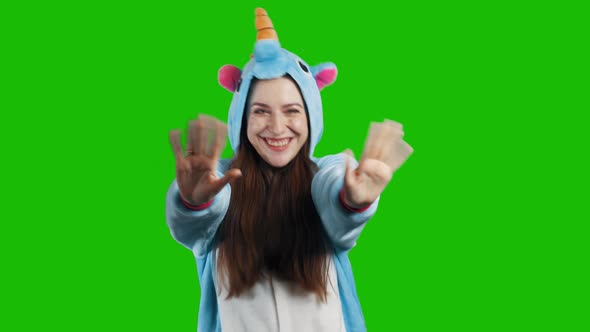 Portrait of a young brunette girl in unicorn costume