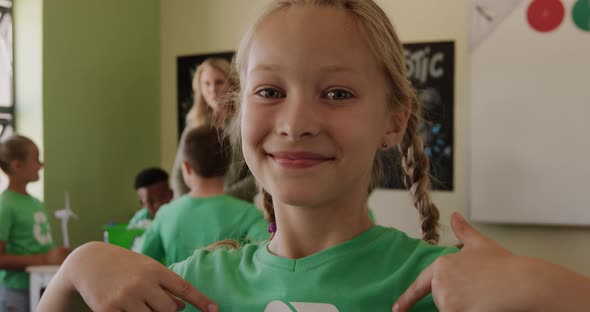 Girl wearing recycle symbol tshirt smiling alt