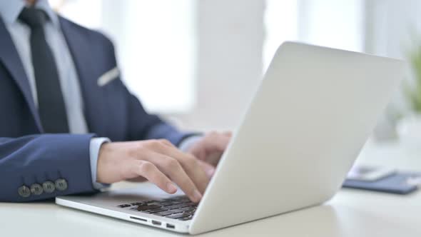 Businessman Typing on Laptop