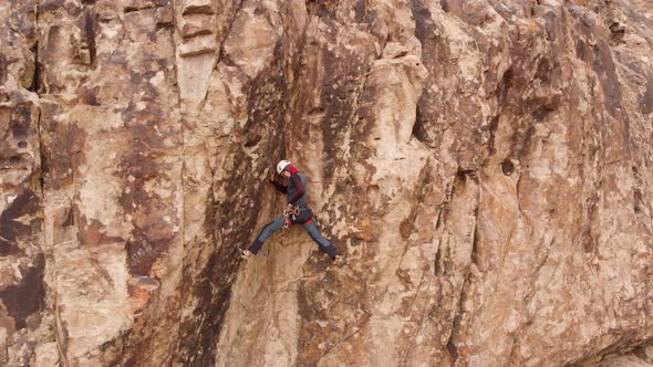 Man Athlette Climbing on the High Rock