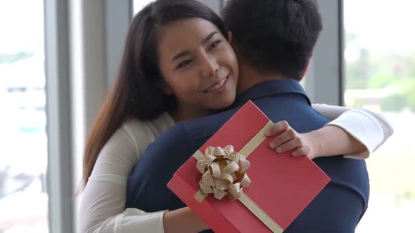 Romantic Couple Giving Gift to Lover at Restaurant