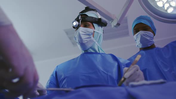 Low angle view of Middle-east female surgeon performing surgery in operation theater at hospital