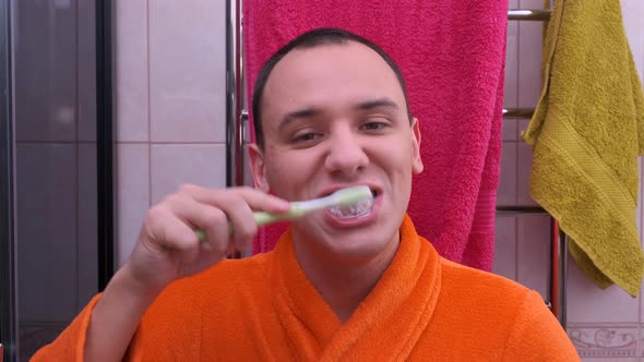 Young Man with Healthy Teeth Holding a Tooth-brush