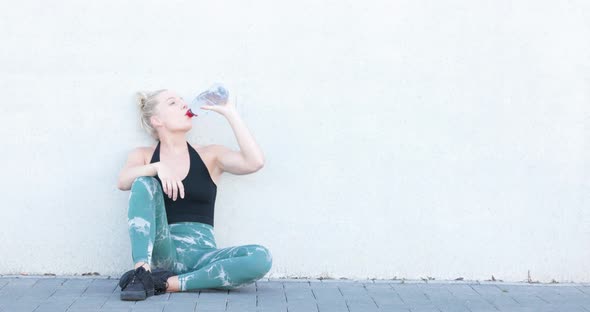 Sport and Lifestyle Concept Sporty Blonde Woman Resting After Doing Sports Outdoors