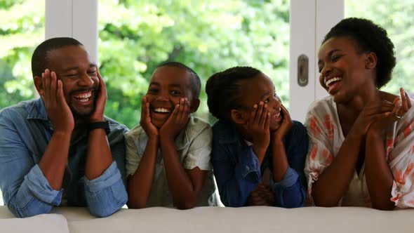 Parents and kids having fun in living room