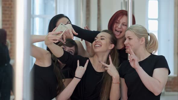 Group of Beautiful Young Women Taking a Selfie After a Pole Dance Class