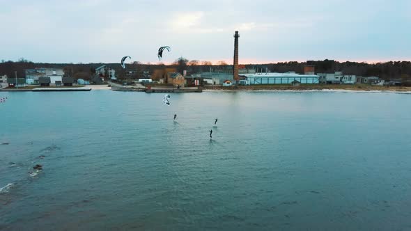 Aerial Drone View of a Corekites Kitesurfers Hydrofoiling  in Engure Port at in Baltic Sea