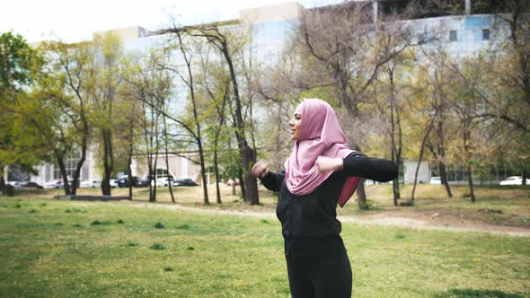 Young Fitness Muslim Woman Doing Sport Excercises Before Run in Park