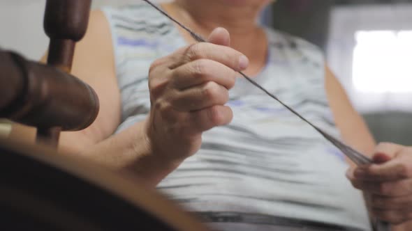 Woman Preparing Yarn To Knitting. Hand of Woman Weaving and Spinning Natural Yarn. Crafts and