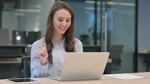 Young Businesswoman Talking on Video Call on Laptop