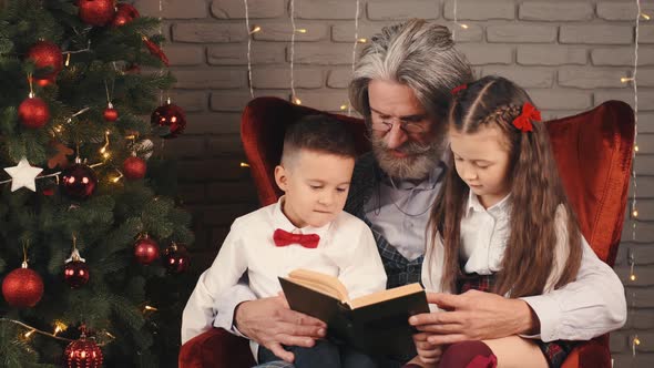 Grandfather and Kids Reading a Book on Christmas Eve