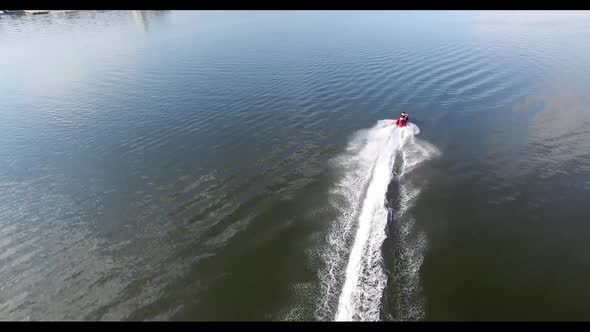 Water Motorcycle Floats on the Wide River. Reflection of Sky