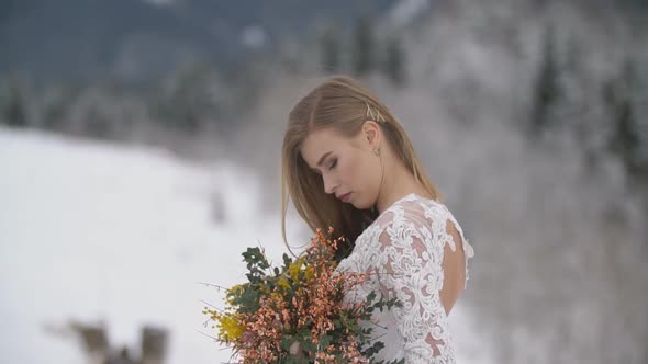 Girl in a White Dress Holding Flowers