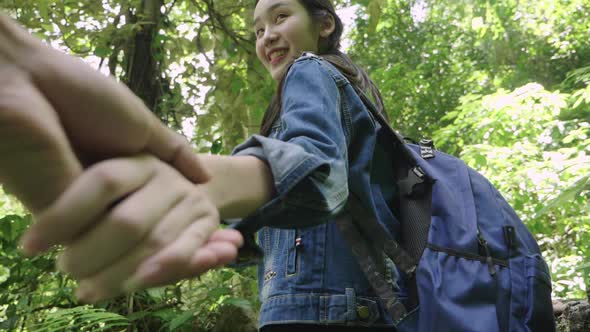 Young Woman Holding Hand Of Her Boyfriend While Hiking